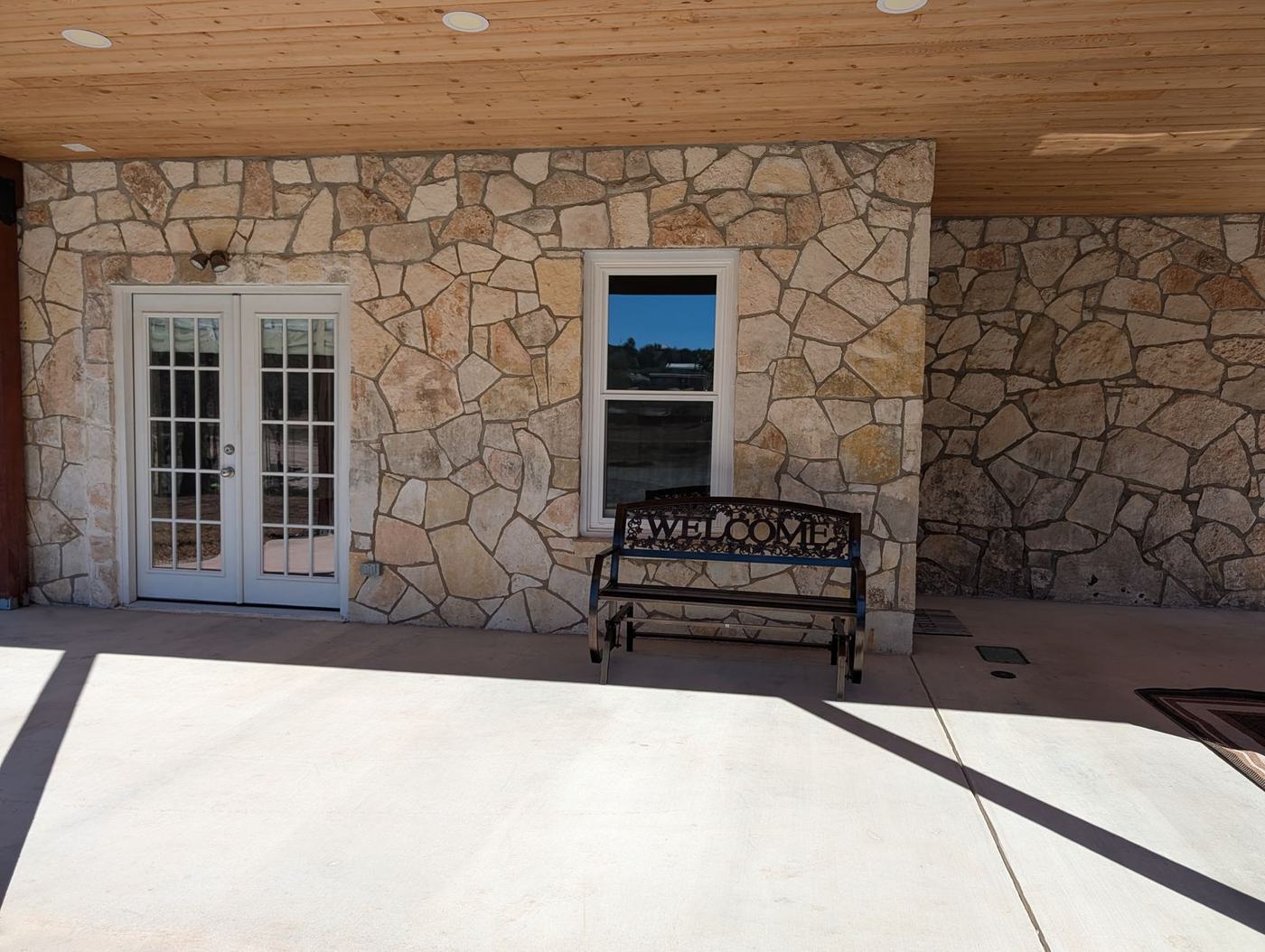 Stone exterior and French doors of the Guest Kitchenette