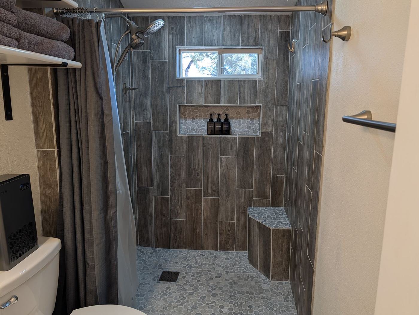 Tiled walk-in shower with bench