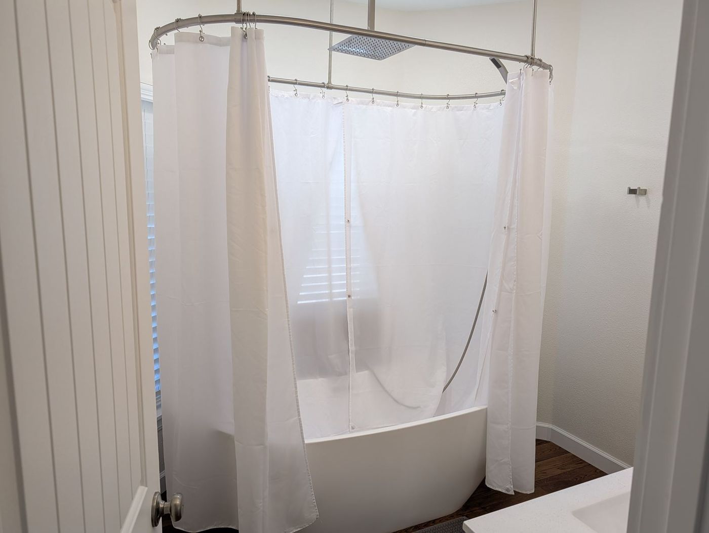 Bathroom with a freestanding soaking tub and rain shower