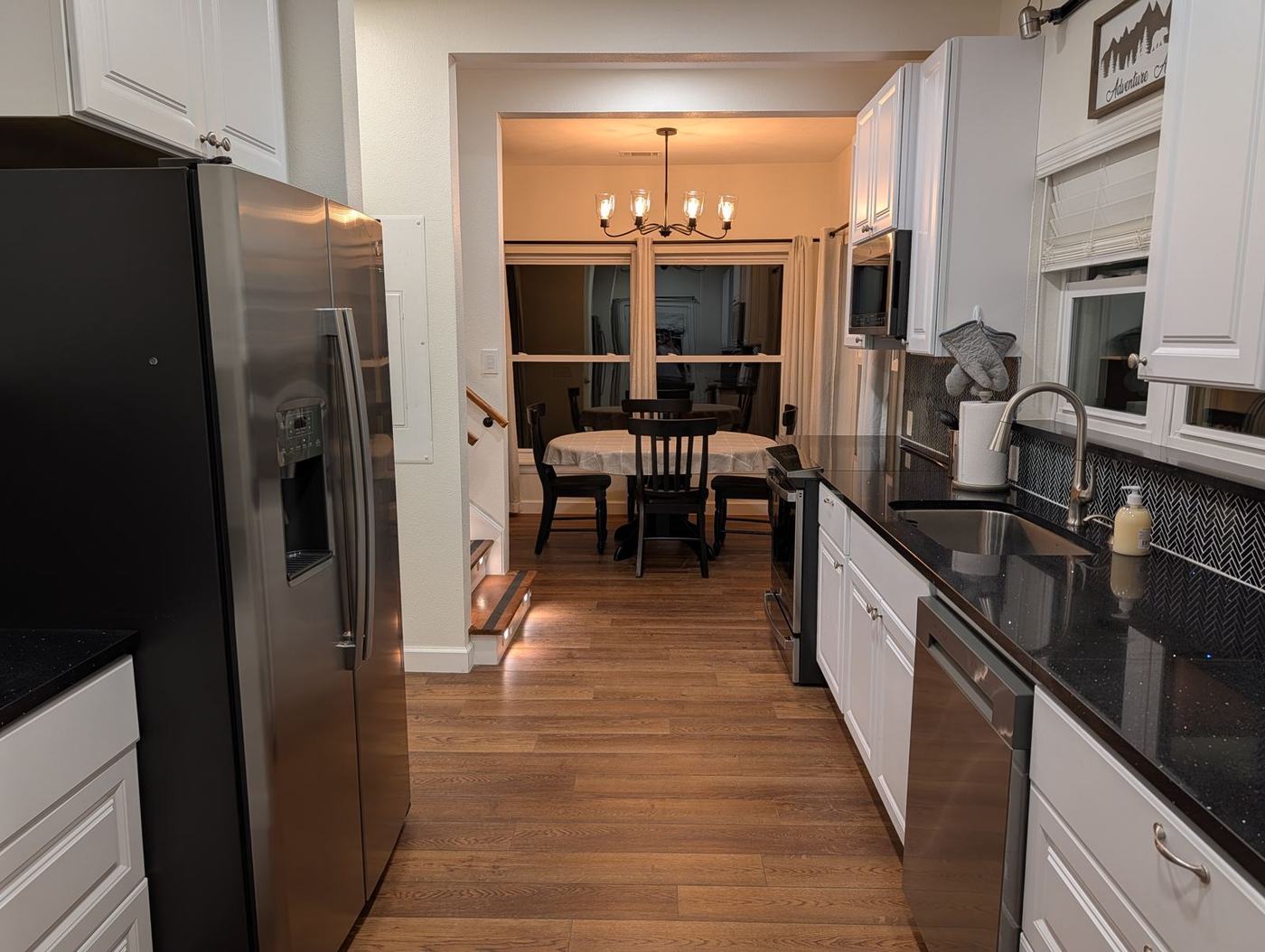 Kitchen with stainless appliances opening to the dining room