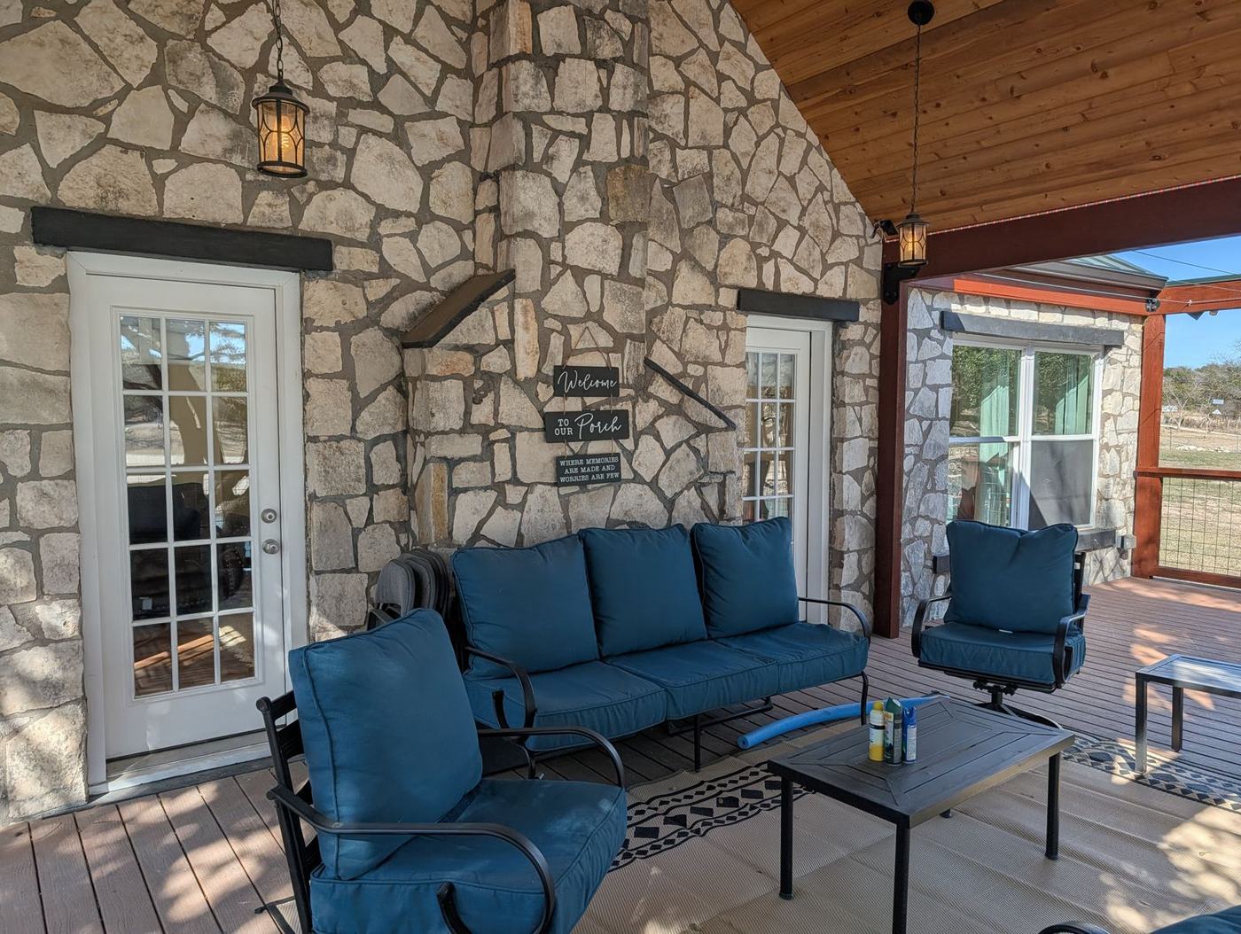 Covered porch seating against the stone wall